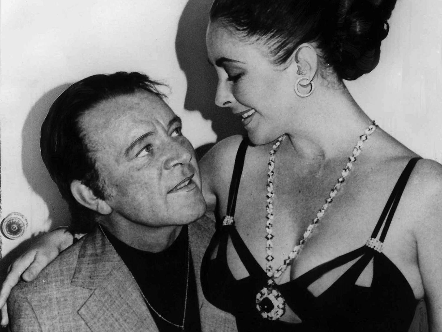 Richard Burton and Elizabeth Taylor who is wearing her sapphire and diamond sautoir.