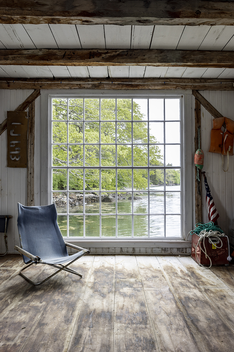 A view of the water through a large window in the dock house.