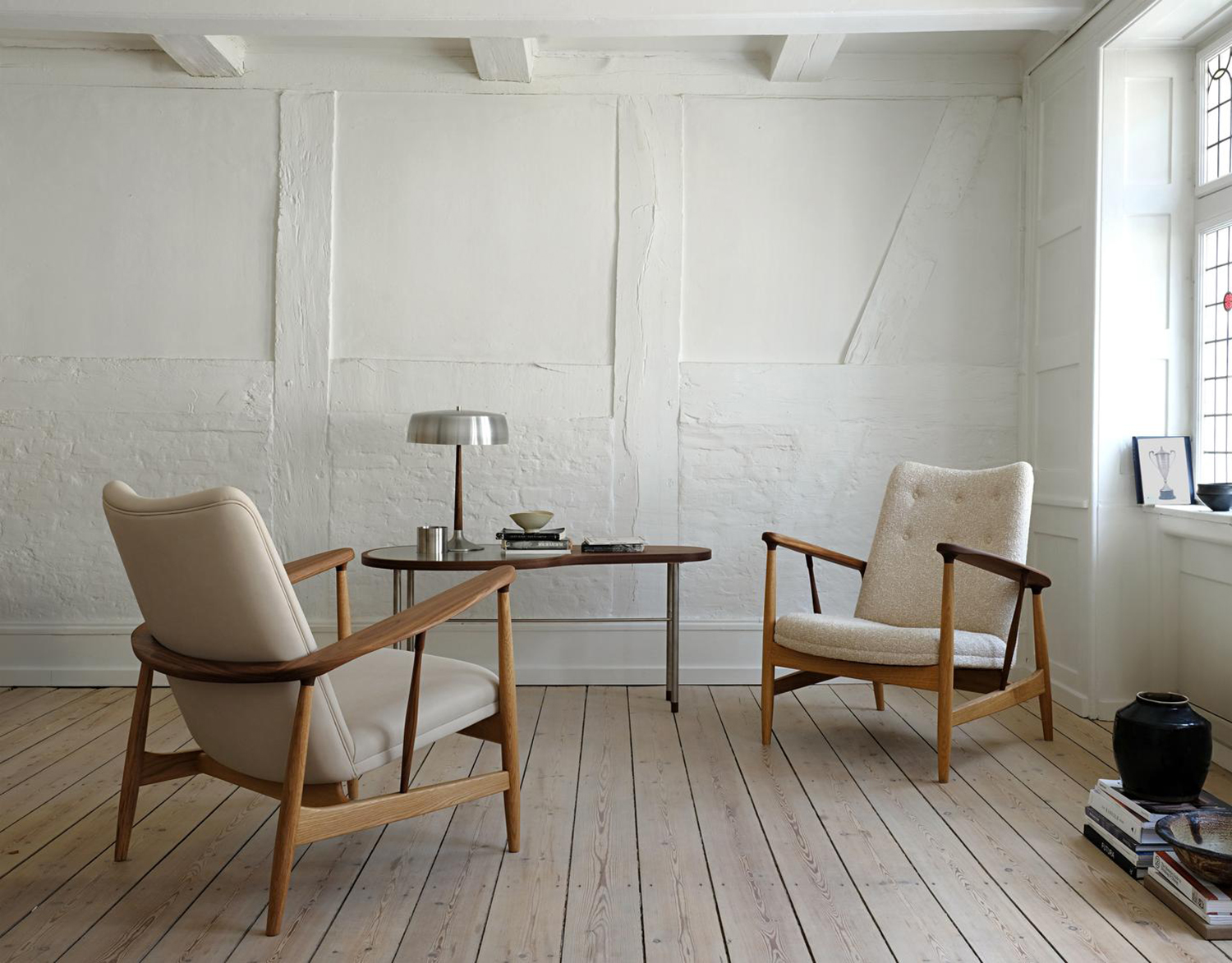 Finn Juhl’s Kettlehut Chair features a frame made of oak and walnut on display in Copenhagen