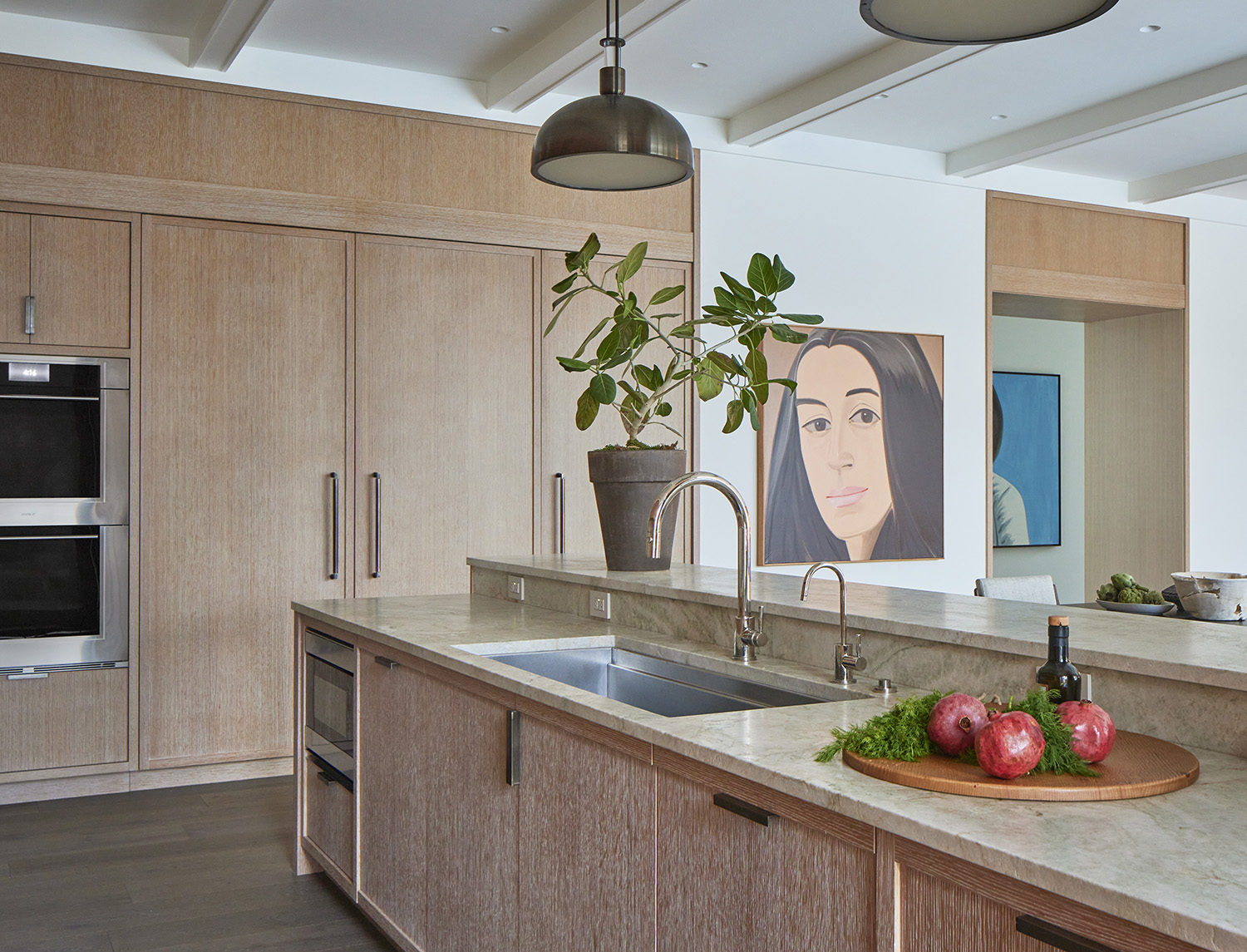 A commanding canvas by American painter Alex Katz overlooks the kitchen in the renovation by Robbins Architecture