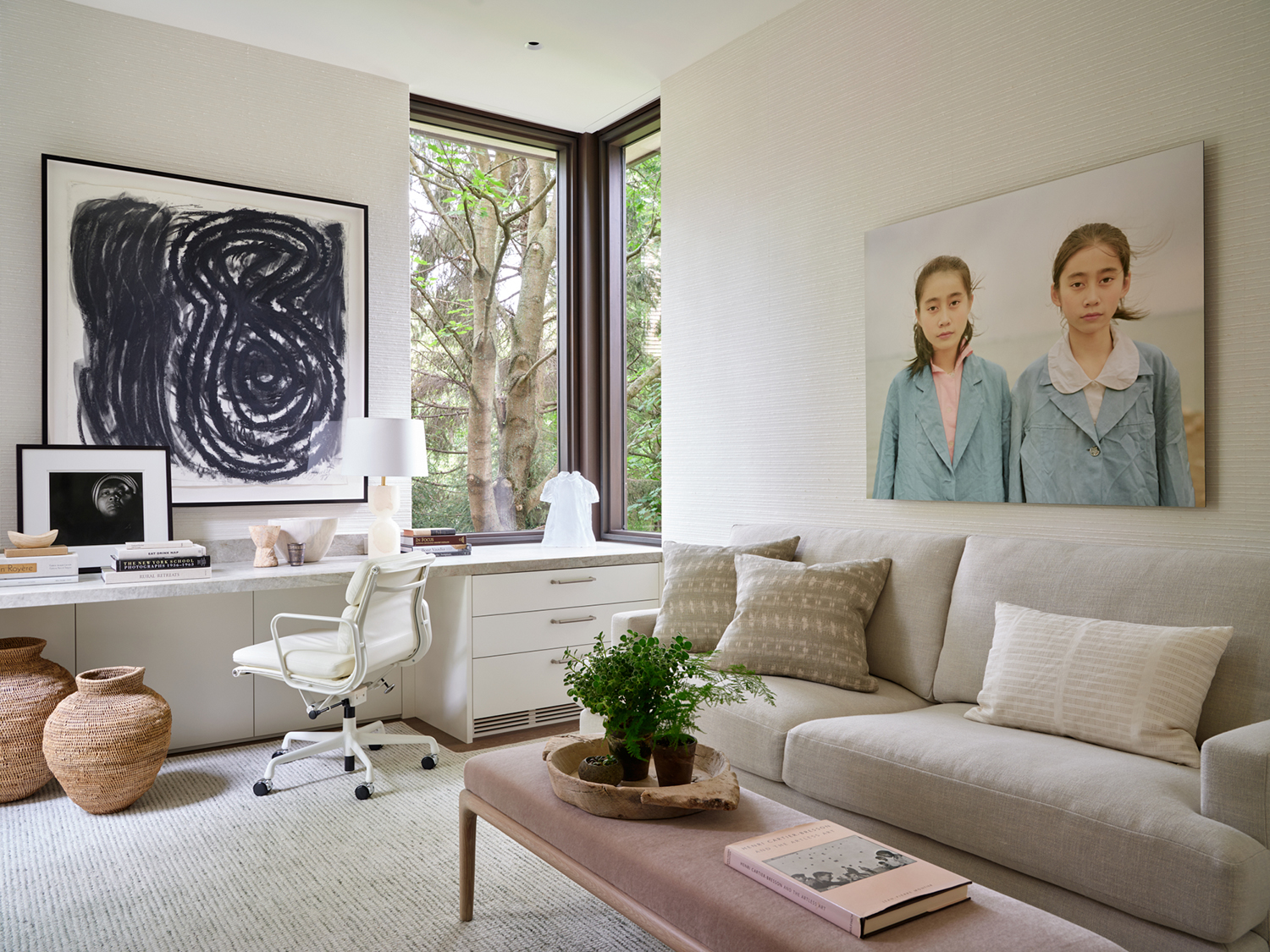 In the office, a piece by English painter Hugh O'Donnell surmounts the desk, with a smaller work by Rashid Johnson in front of it in the renovation completed by Robbins Architecture