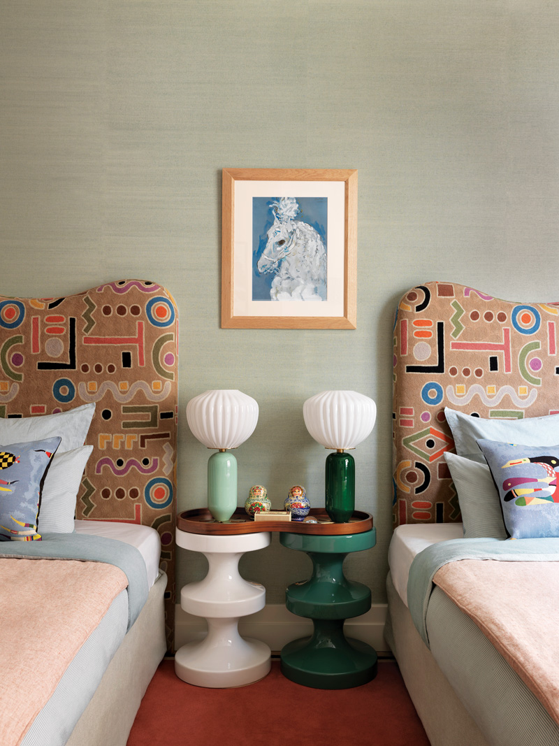 Shapely headboards in a Clarence House fabric define a guest room by designer Laura Gonzalez.