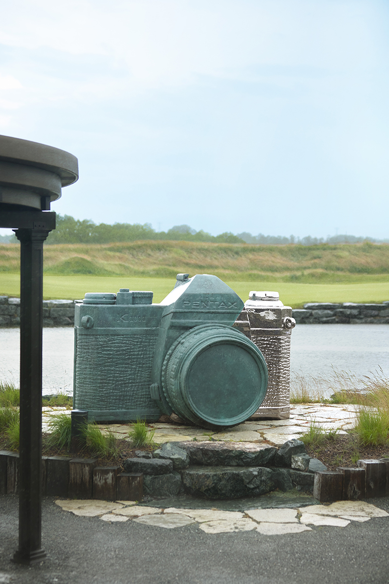 Bronze Eroded Pentax Camera by Daniel Arsham, installed on The Baths golf course at Blackwolf Run.