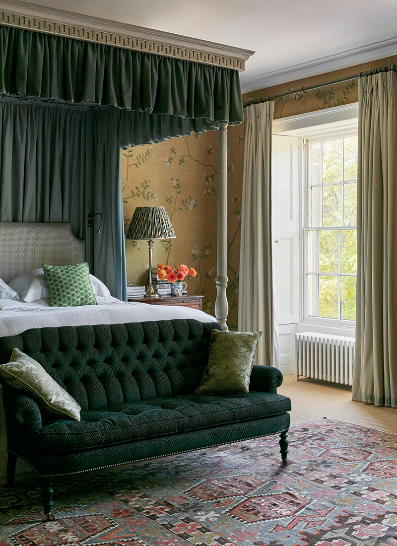 Ben Pentreath reimagined the primary bedroom with a de Gournay wallpaper, anchored by a Beaudesert bed with a headboard in a Veere Grenney fabric and a canopy made with fabrics by Holland & Sherry and Claremont.