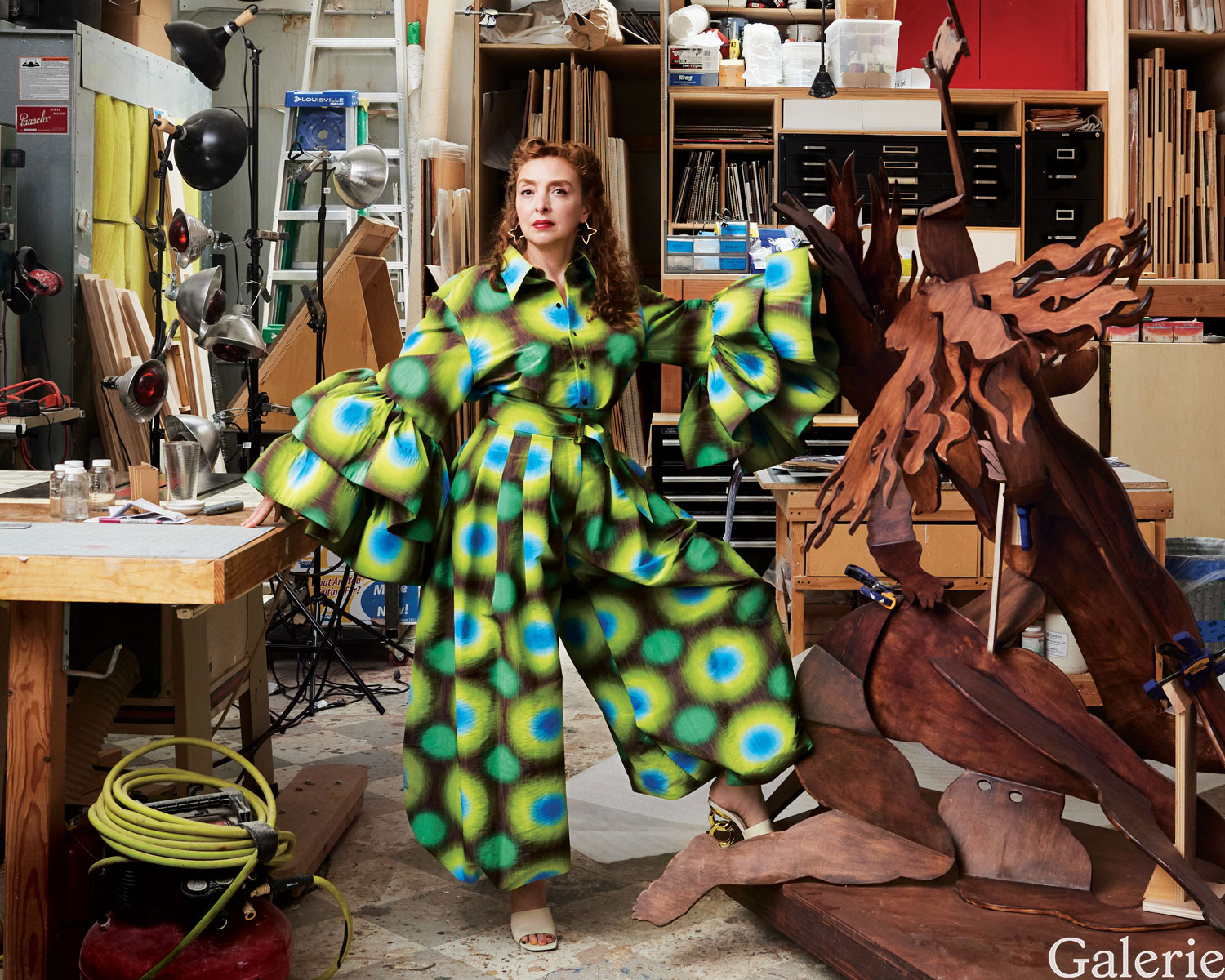 In her Manhattan studio, Rachel Feinstein stands next to her 2020 sculpture Metal Storm. She is wearing a minidress and pants by Christopher John Rogers, Louis Vuitton earrings, and Kat Maconie shoes. Styling by Newheart Ohanian.