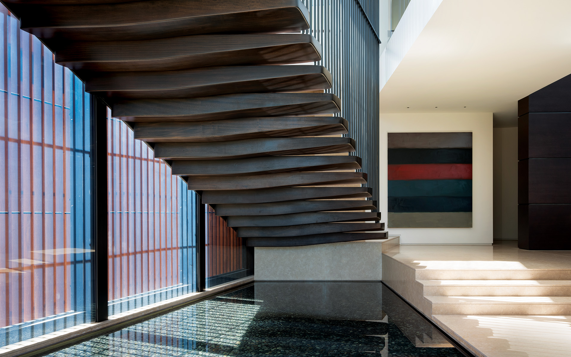 Magni Kalman Design’s James Magni and Jason Kalman conceived this floating stair in Los Angeles with interior rails that mirror the exterior louvers to create a stunning shadow effect. The water feature extends from the outside in, and the artwork is by Sean Scully.