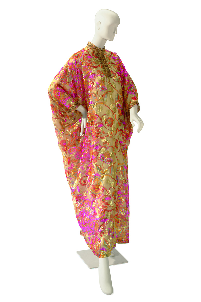 Ashley Longshore favors a beige ground floral print and gold lamé embroidered caftan labeled Saks Fifth Avenue from the 2011 “Collection of Elizabeth Taylor: Fashion and Accessories” auction at Christie's.