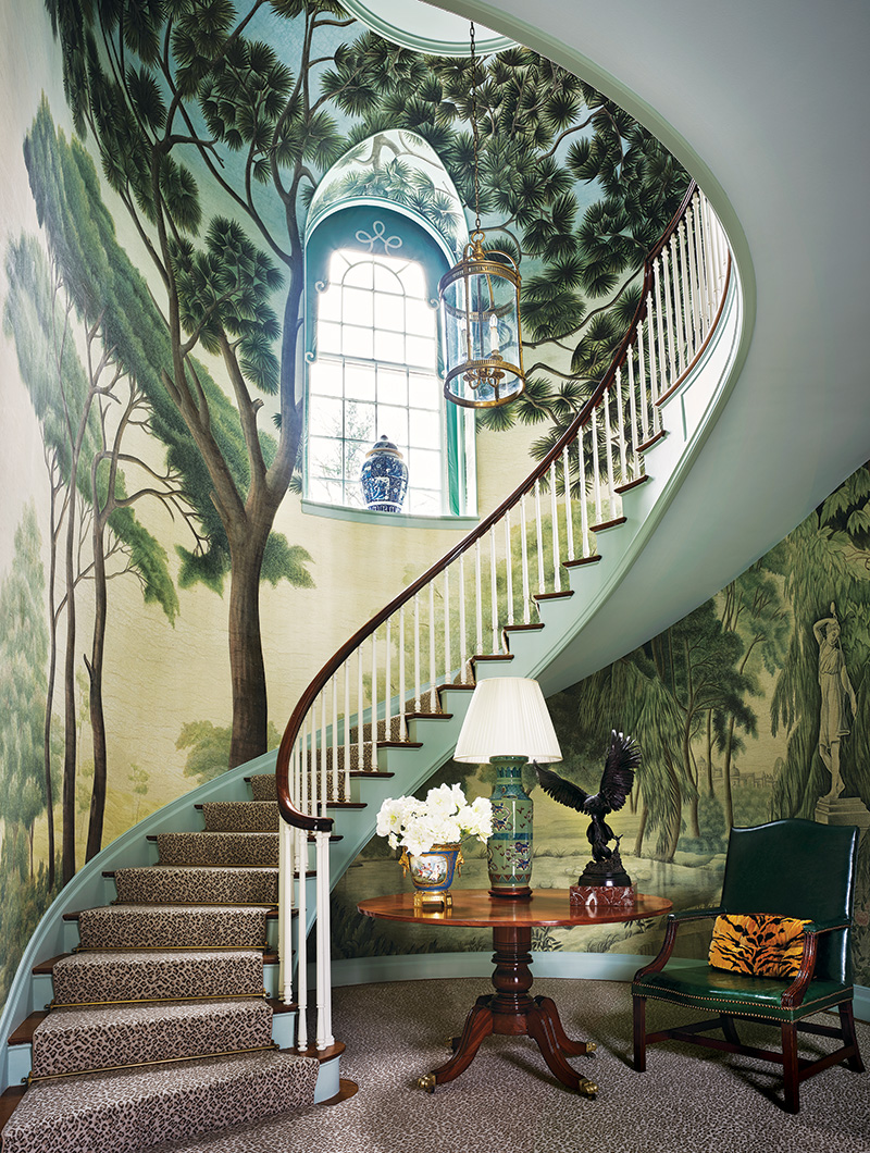 In a Connecticut home, Redd Kaihoi enveloped a sweeping spiral stairway in an Iksel mural, customizing the wall covering with life-size trees.