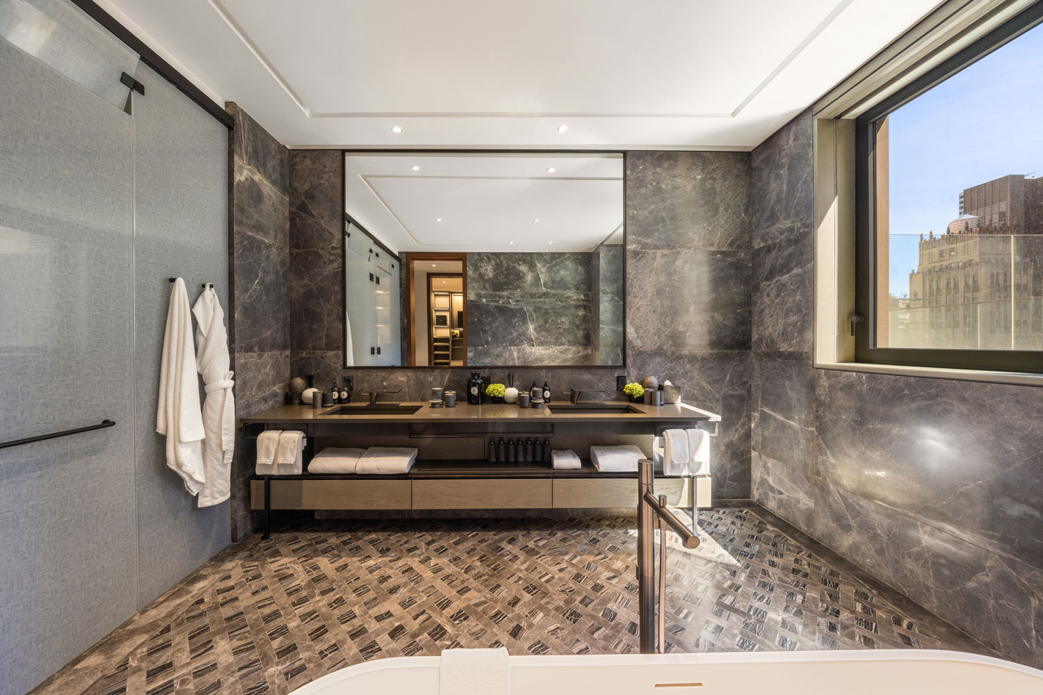 The bathroom of the Crown Building residences features spa-like amenities.