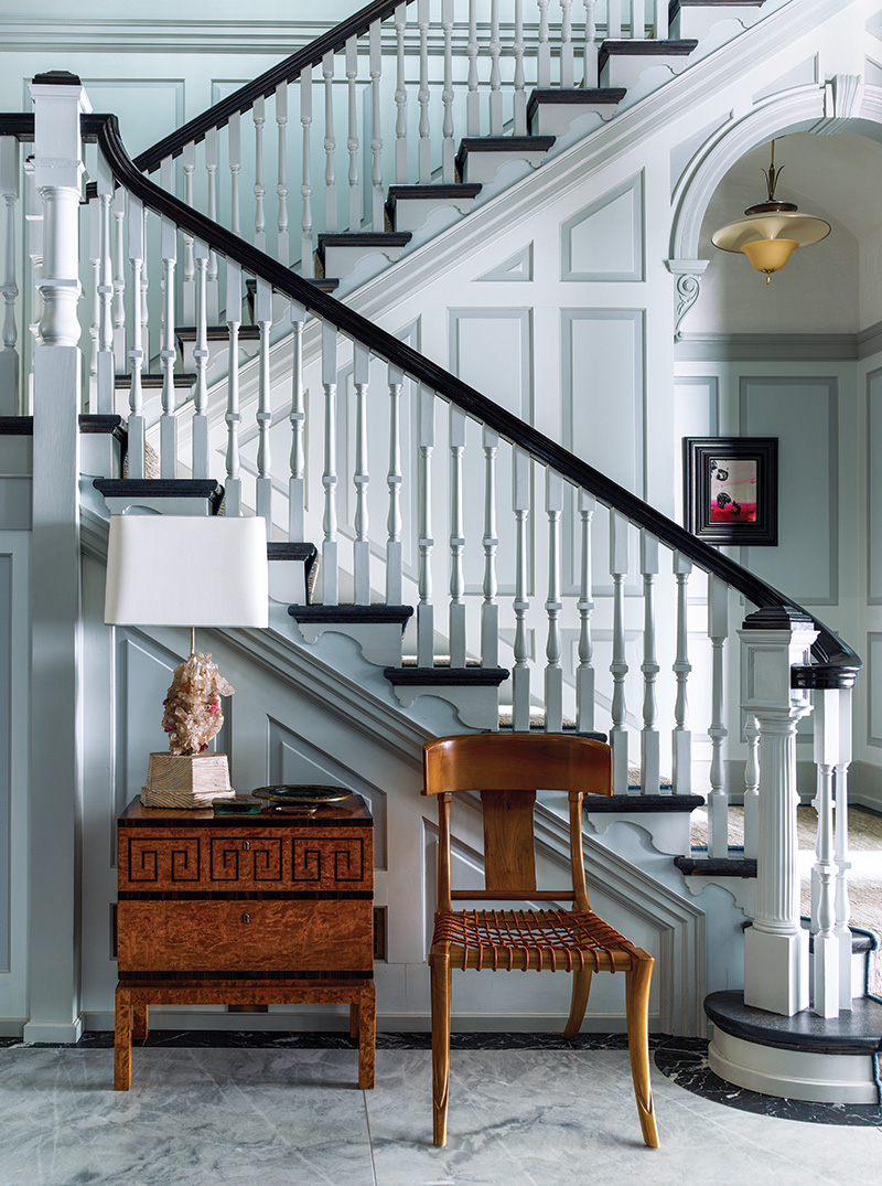 For a historic home in Philadelphia, Steven Gambrel softened the stairway's multitude of architectural details with a palette of misty blues and grays.