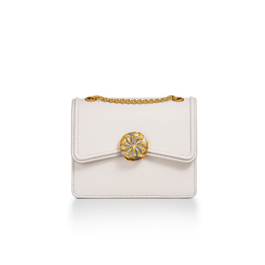 The closure on each handbag is offered in one of four iterations: bicolor, enamel, gold vermeil and 18k gold with diamonds.