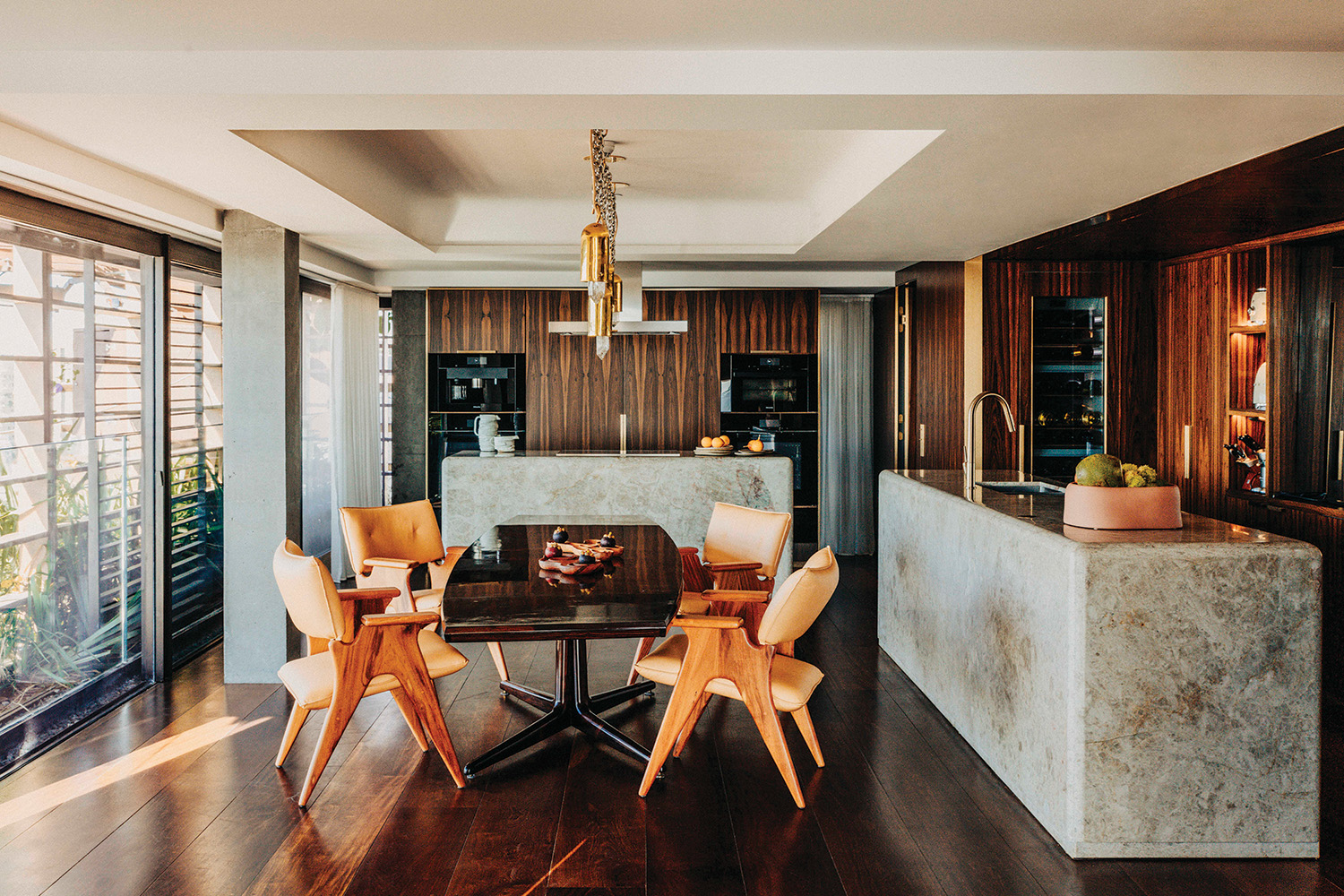 The eat-in kitchen features wood, stone, and fabric from Brazil at the Rosewood São Paulo.