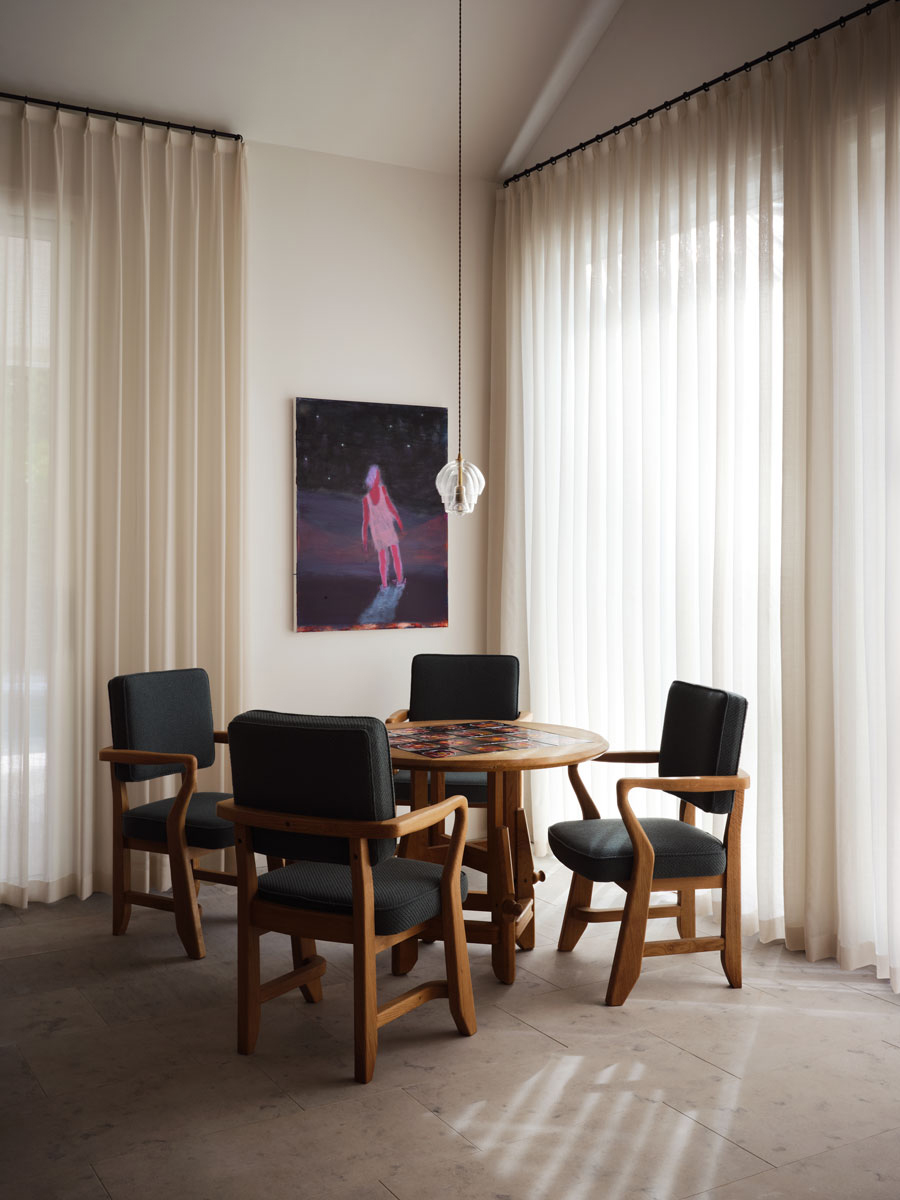 Table and chairs by Guillereme et Chambron. Art by Katherine Bradford. Pendant by Amy Meier.