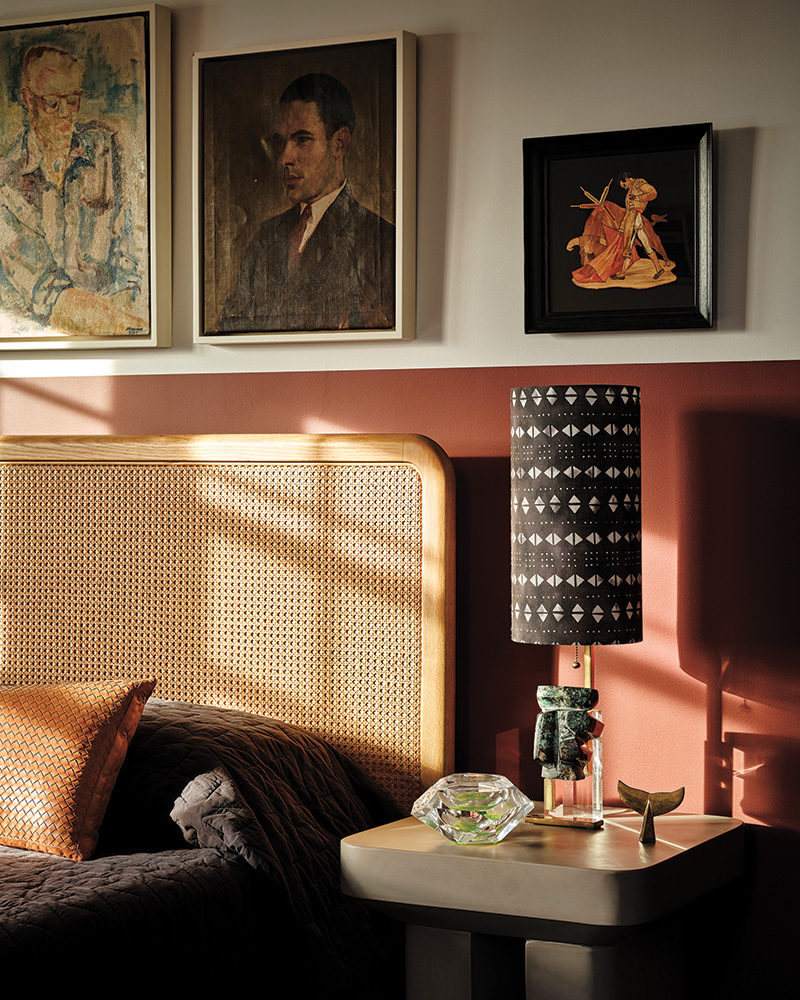 Other selections from designer's collection of art are displayed above the Soho Home bed in the primary suite.