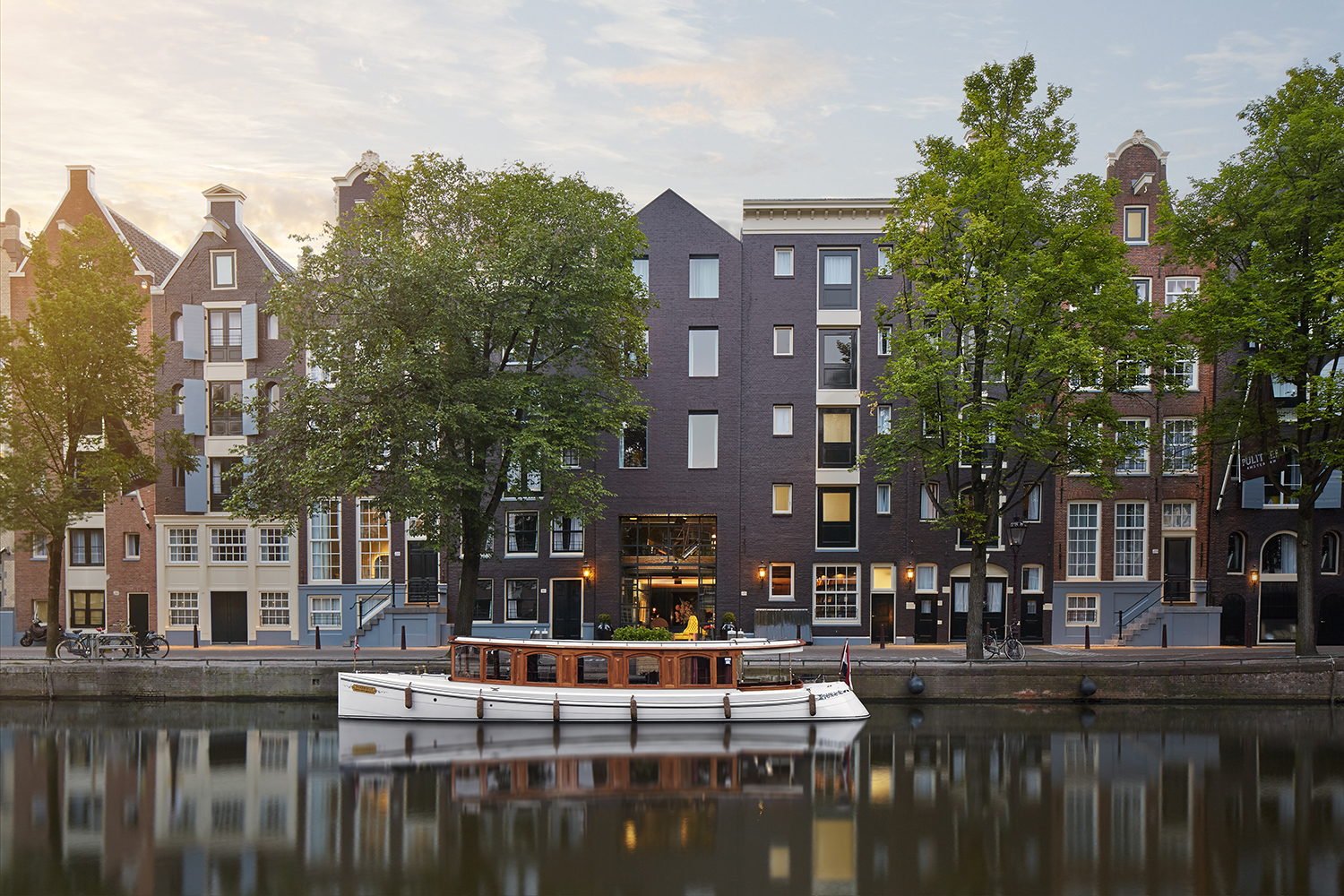 Exterior of the Pulitzer Amsterdam and the hotel's treasured canal boat.