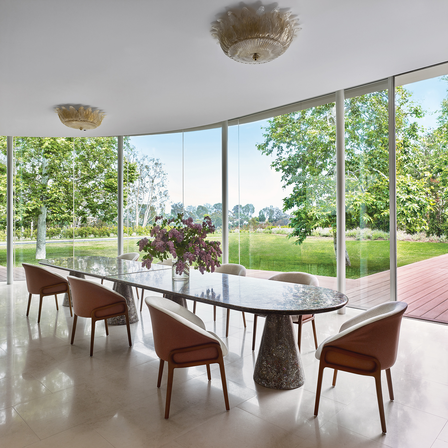 Vintage Murano glass light fixtures by Barovier & Toso add glamour to the dining room, which Ernest de la Torre anchored with a Dirk van der Kooij table made from recycled plastic surrounded by Simonini chairs.