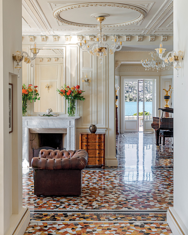 On the main floor, light-filled salons with exuberant terrazzo flooring and elegant neoclassical plaster details offer spectacular views across Lake Como.