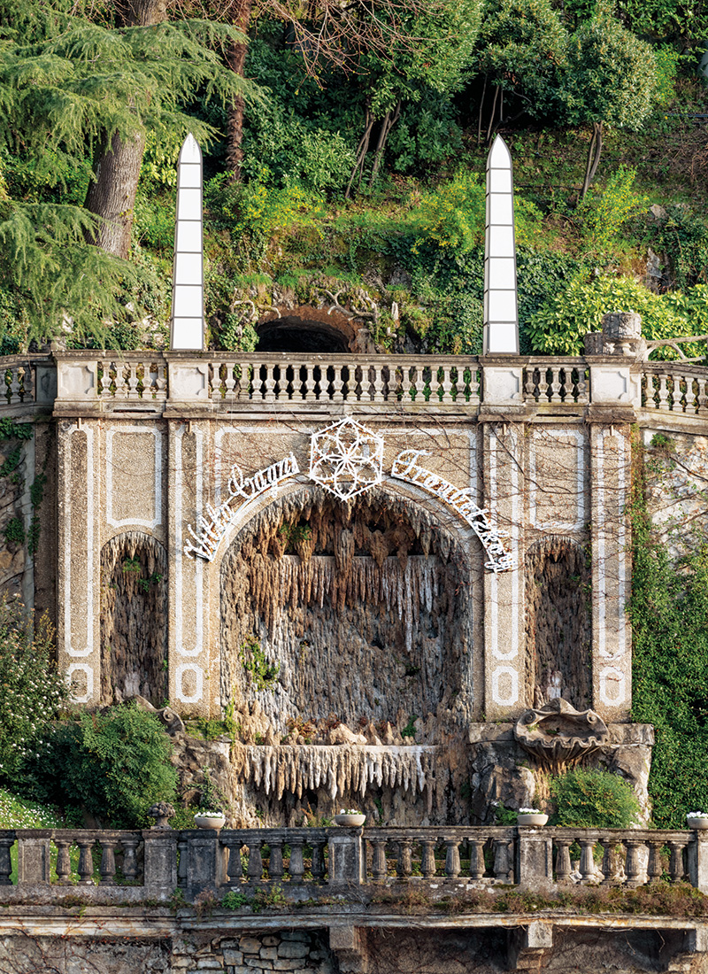 The restored gardens feature a grotto fountain with ornate rocaille decoration on Lake Como.