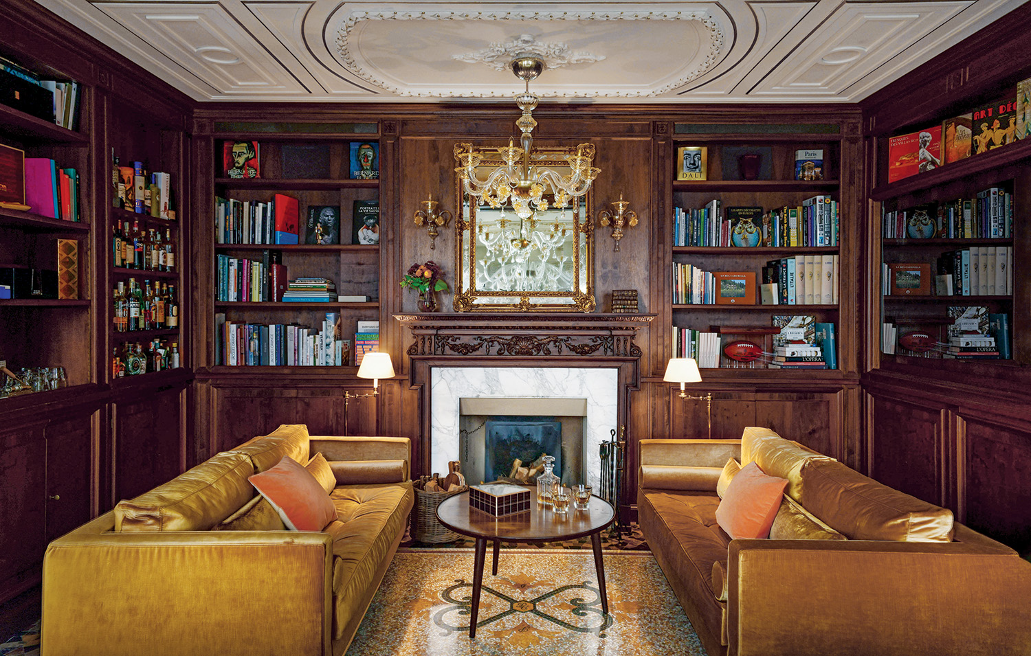 In the inviting paneled library, the floor features a scrolling motif that incorporates the initials of Cagni family members.