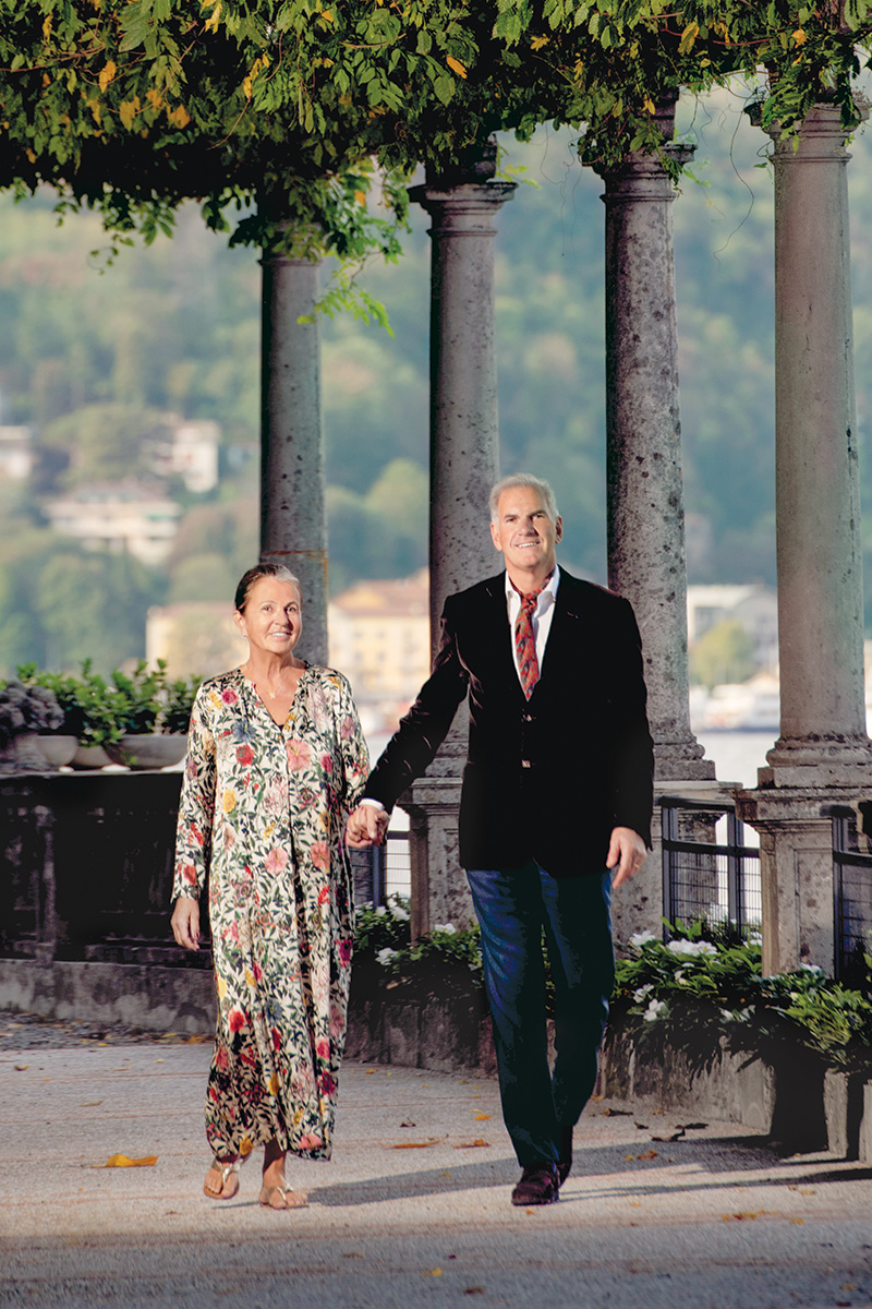 Catherine and Pascal Cagni stroll along a terrace at the villa on Lake Como.