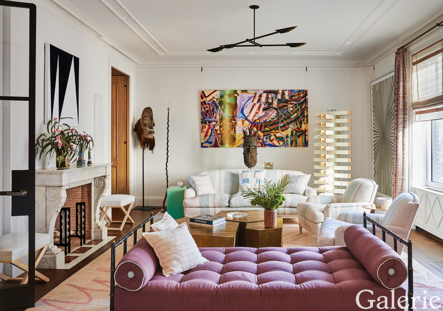 Designer Frank de Biasi furnished the space with a sofa and armchairs by Maison Carlhian that he upholstered in a fabric of his own design, grouping them with a Jacques Adnet daybed around a cocktail table by Gloria Cortina.