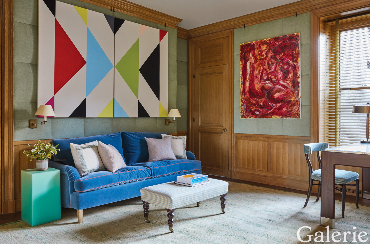 In the library, a geometric abstraction by Sarah Crowner and a painting by Jo Messer are displayed atop panels made of a Le Manach fabric; Dutruc Rosset lighting sconces are mounted above the sofa, which was designed by Frank de Biasi and is covered in a Manufacture Royale Bonvallet mohair velvet.