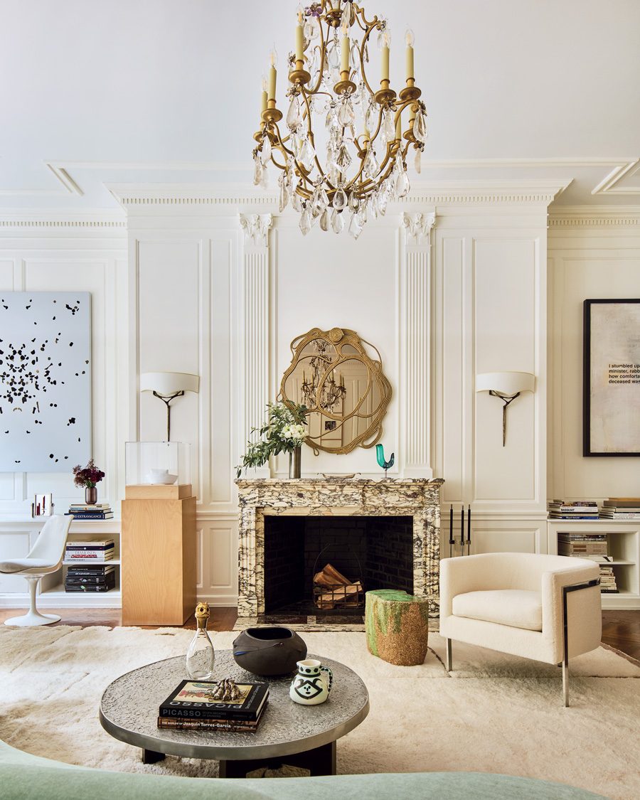 In the salon, a Campana Brothers mirror from Friedman Benda hangs above a marble fireplace