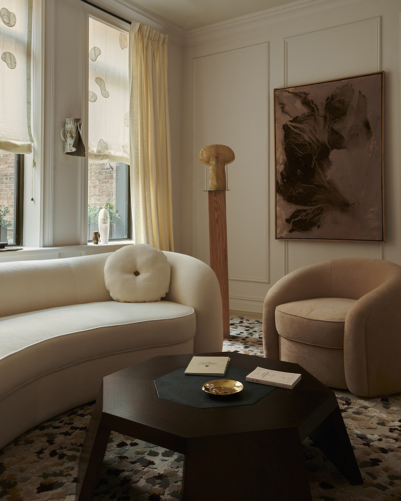 Jacques Doucet Avenue Du Bois sofa and armchair paired with the Apollinaire cocktail table and Seurat rug, designed by Garcé & Dimofski for the Invisible Collection.