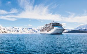 The Regent Seven Seas Explorer cruises past the majestic Alaskan coastline.