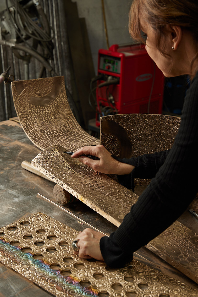 Ingrid Donant at work on the ornate facade of her Commode Skarabée.