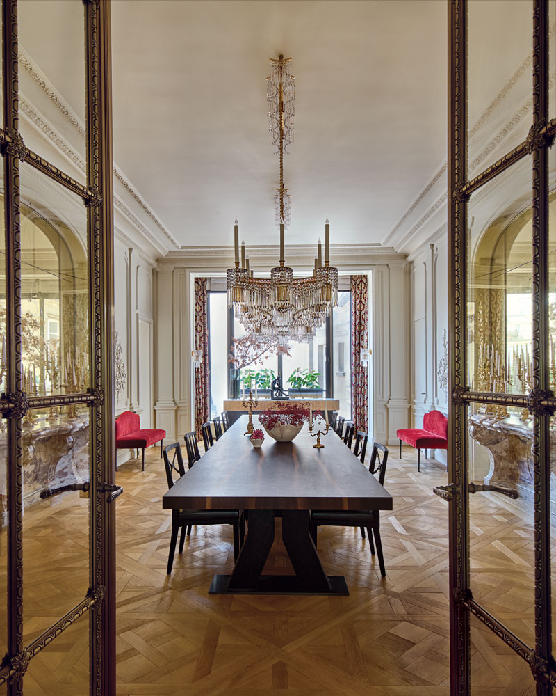 Hazarian installed a spectacular 1920s Art Deco chandelier from Spain above the table and chairs she designed for the dining room, which also features antique marble consoles, custom velvet-clad benches, curtains in a Fadini-Borghi fabric, and parquet de Versailles flooring by Féau Boiseries.