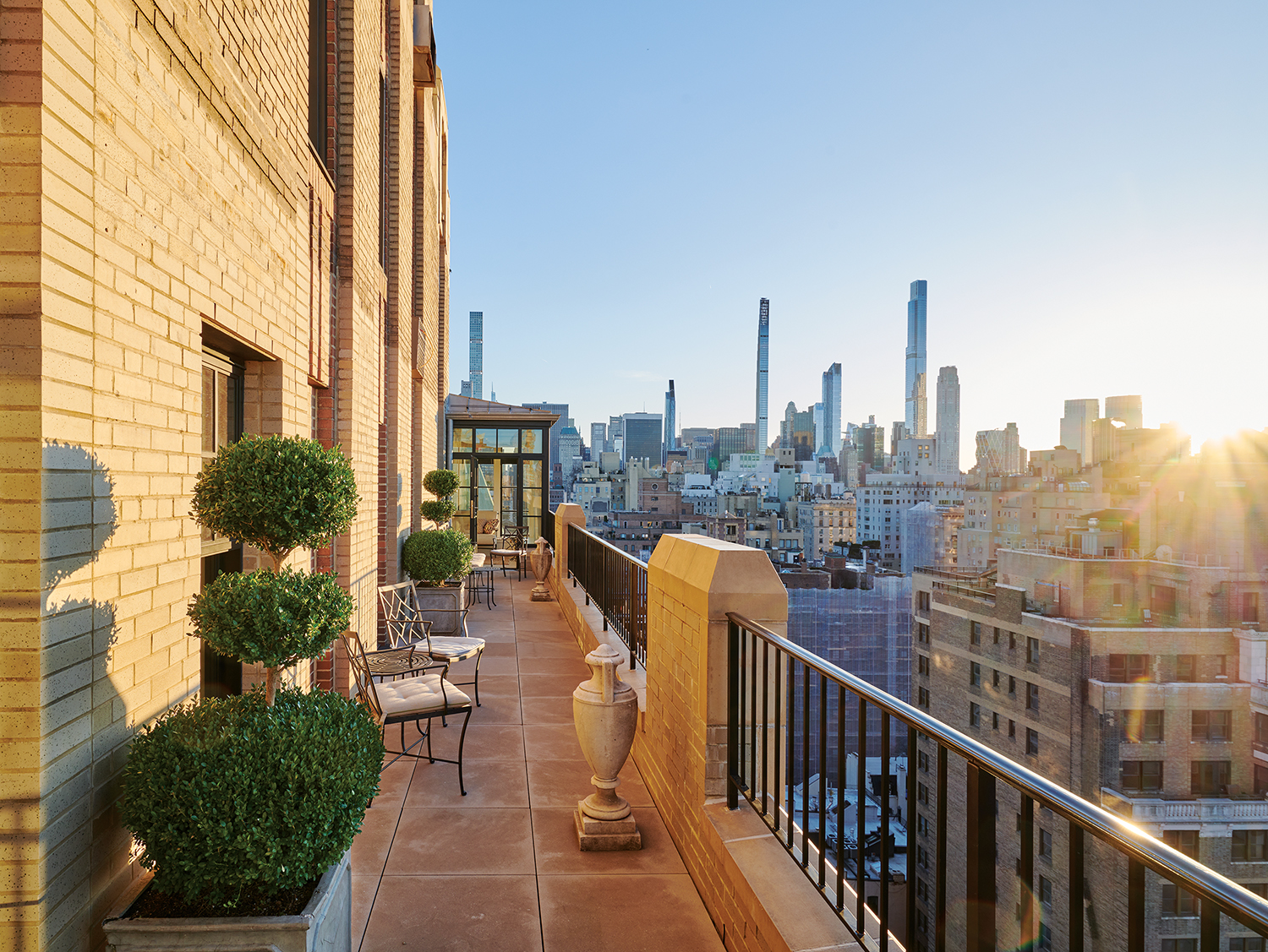 Offering spectacular views of Central Park and midtown Manhattan, the 45-foot-long terrace is furnished with chairs and custom-designed tables, all made by Munder Skiles.