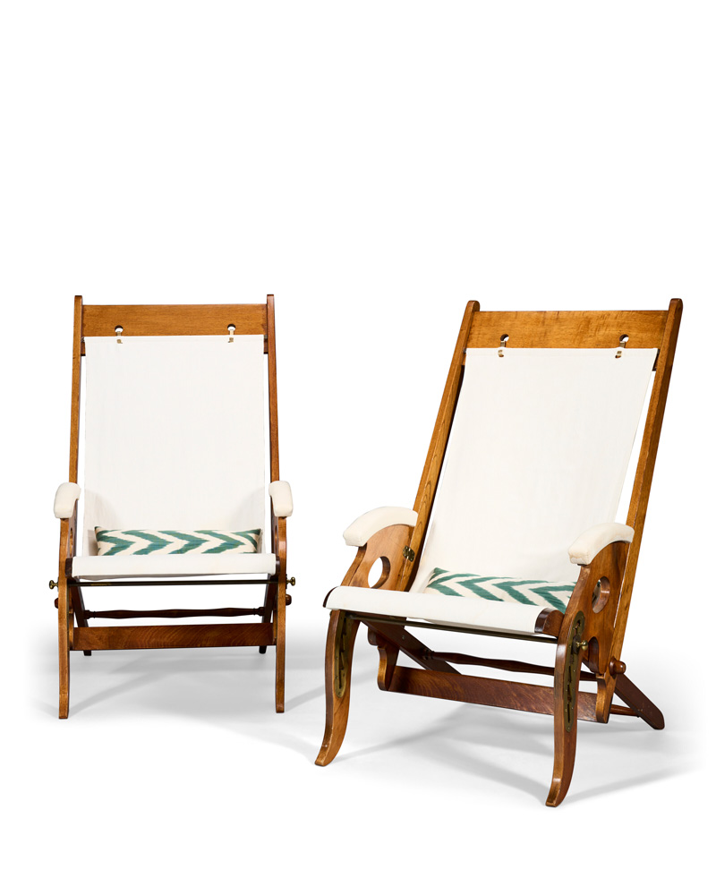 A pair of mahogany and canvas folding campaign armchairs.