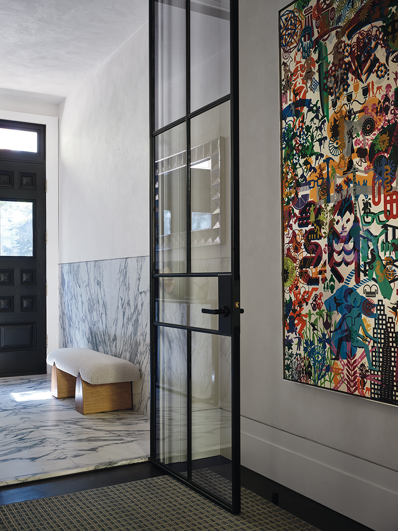 A Ryan McGinness painting animates the home’s entryway.