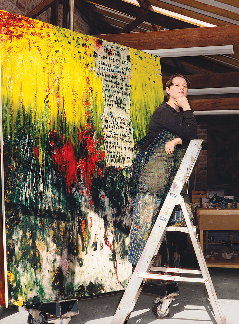 Portrait of artist Daisy Parris in front of a painting.