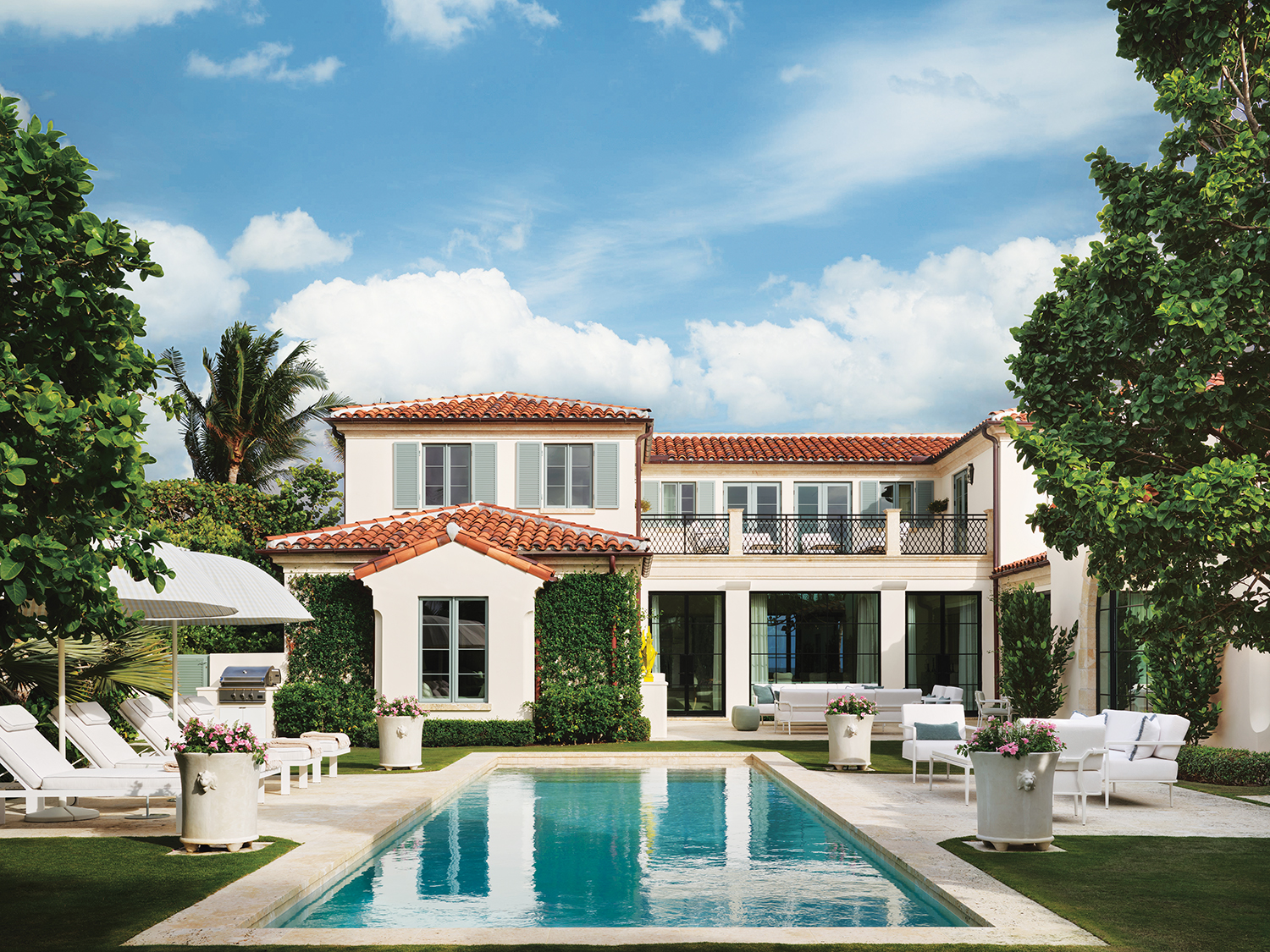 The pool terraces are outfitted with FBC London furniture and Paola Lenti umbrellas.