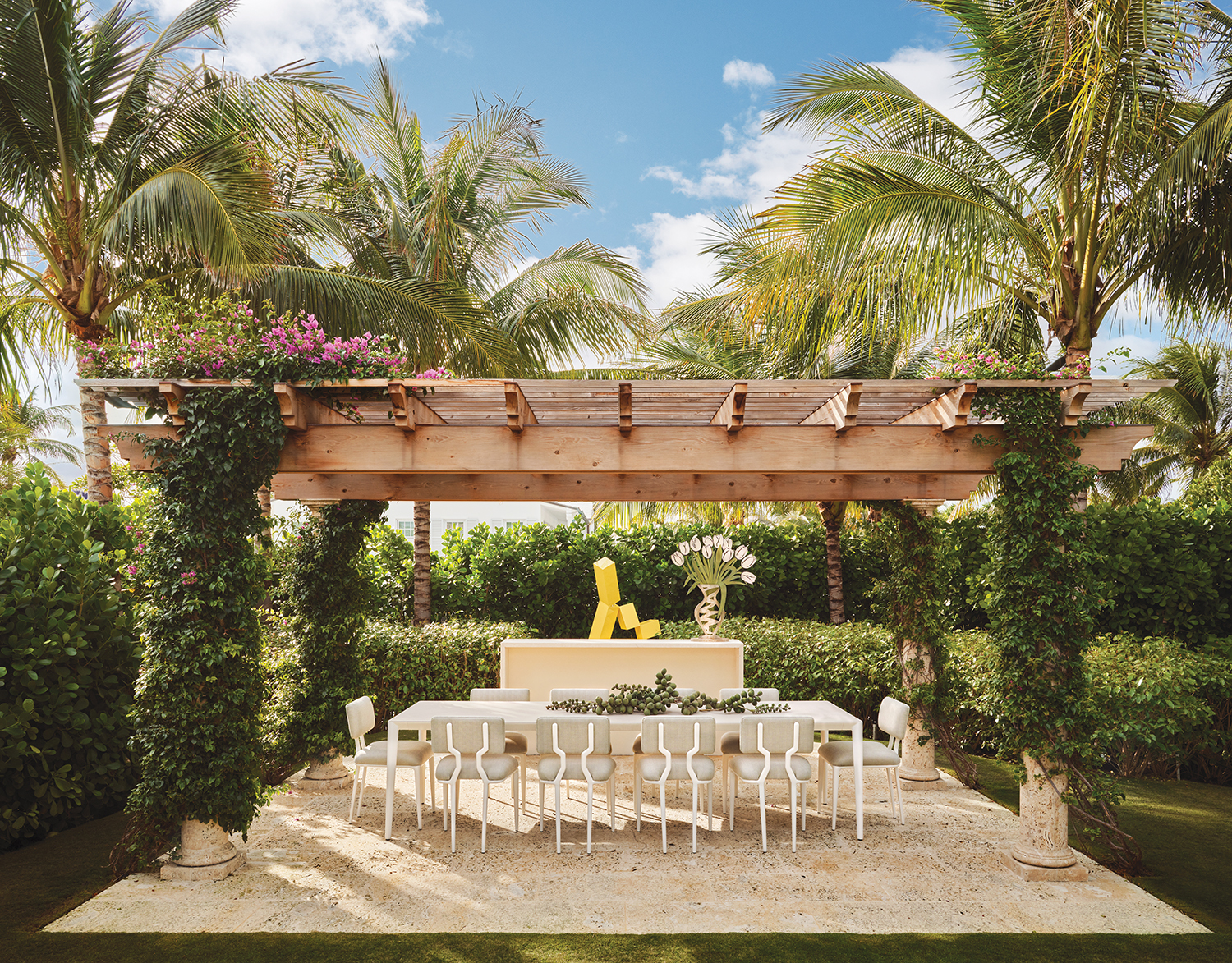 SMI Landscape Architecture oversaw the grounds and designed the pergola-shaded coral stone dining pavilion, which is furnished with a Royal Botania table and FBC London chairs. The sculptures are by Jane Manus (left) and Babette Bloch.