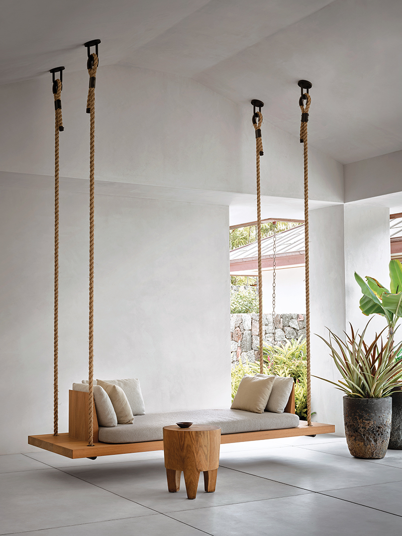 A hanging daybed by Hollis offers a spot for quiet repose at one end of the great room lanai.