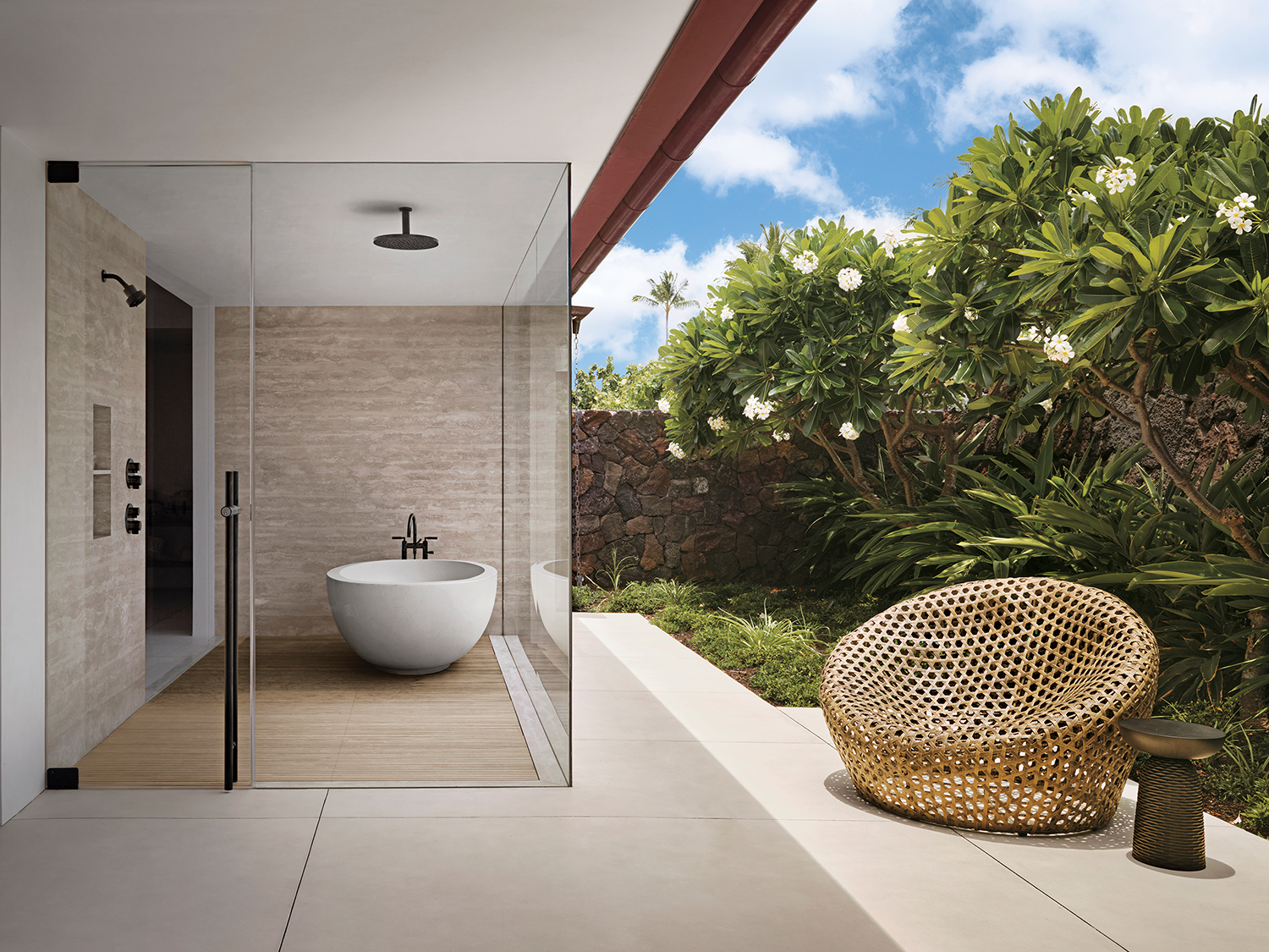 The primary bath features an outdoor shower area with Dornbracht fixtures and a Manos by Concreteworks cast-concrete tub on a custom slatted teak mat.