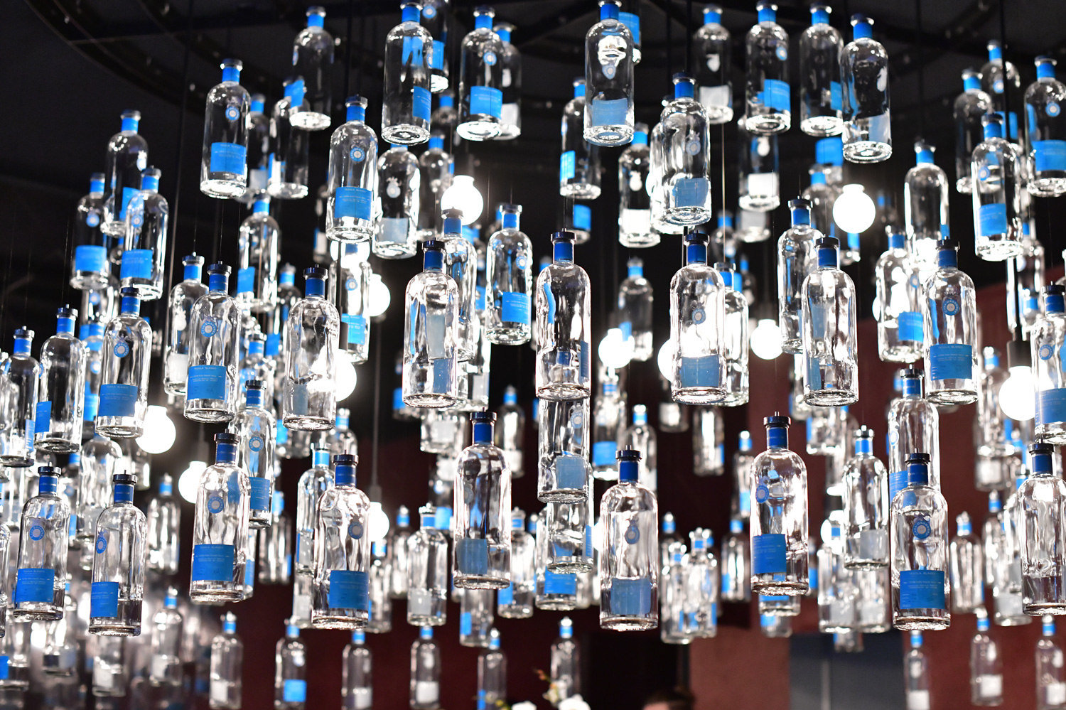 The bottle chandelier inside the Casa Dragones “Quiote Bar.