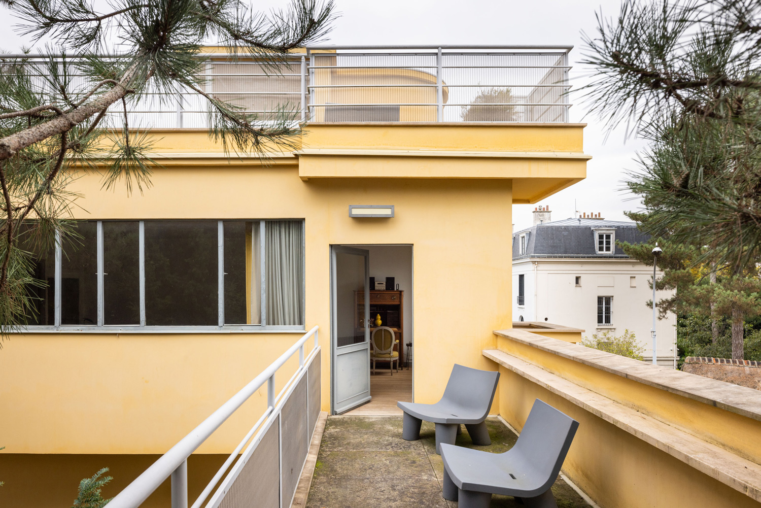 An elevated walkway between the main building and the nearby outbuilding.