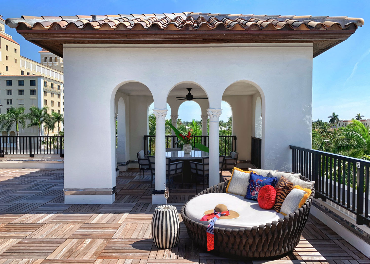 Outdoor bed seen on large terrace of hotel suite.