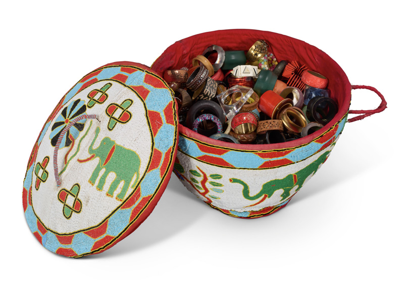 A LARGE BEADED BASKET OF BANGLES from the Iris Apfel collection.