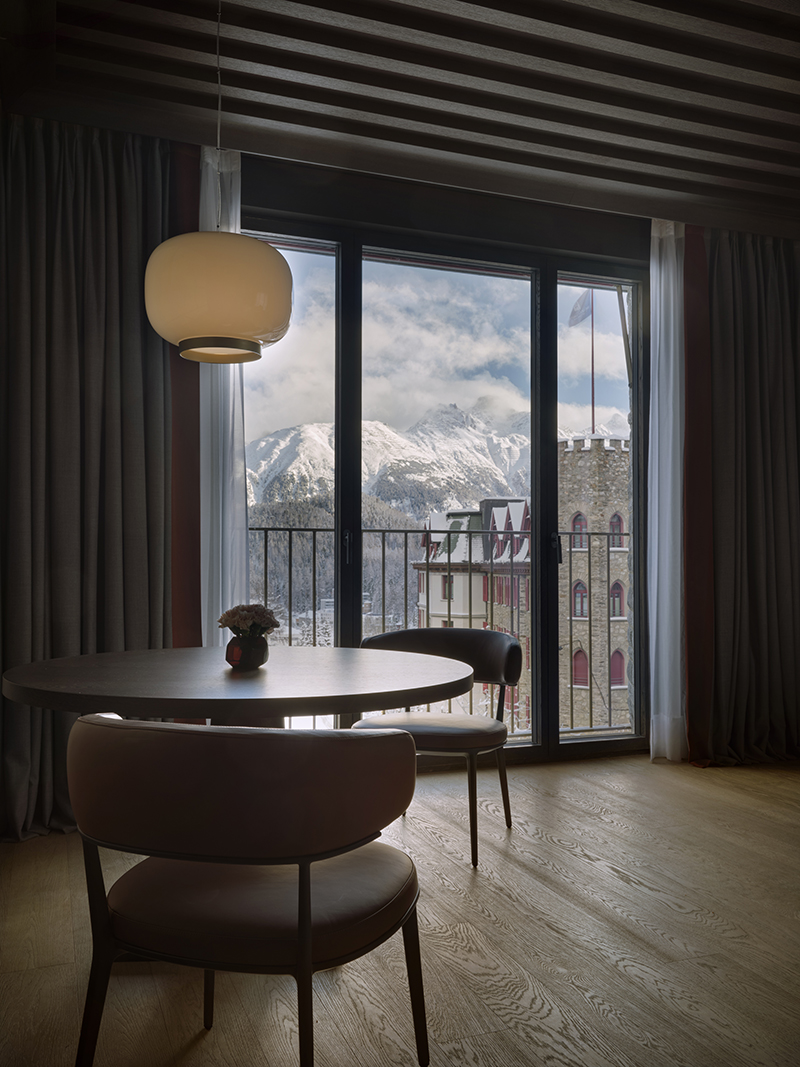 Windows inside the new Serlas Wing frame the view of Badrutt's Palace Hotel and surrounding mountain range.