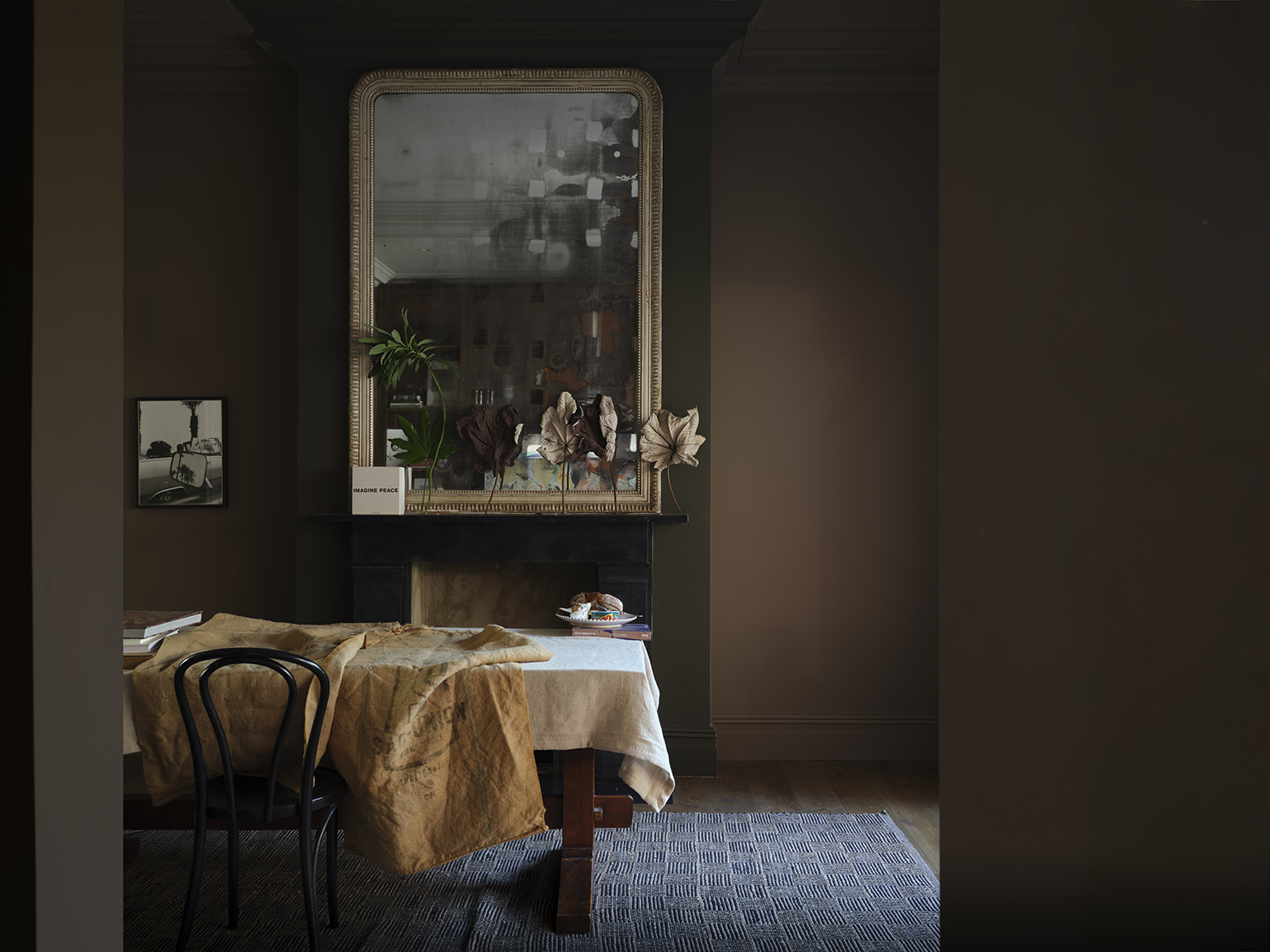 Walls and woodwork painted in Broccoli Brown No.198 while the chimney breast is rendered in Reduced Green No.313 by Farrow & Ball.