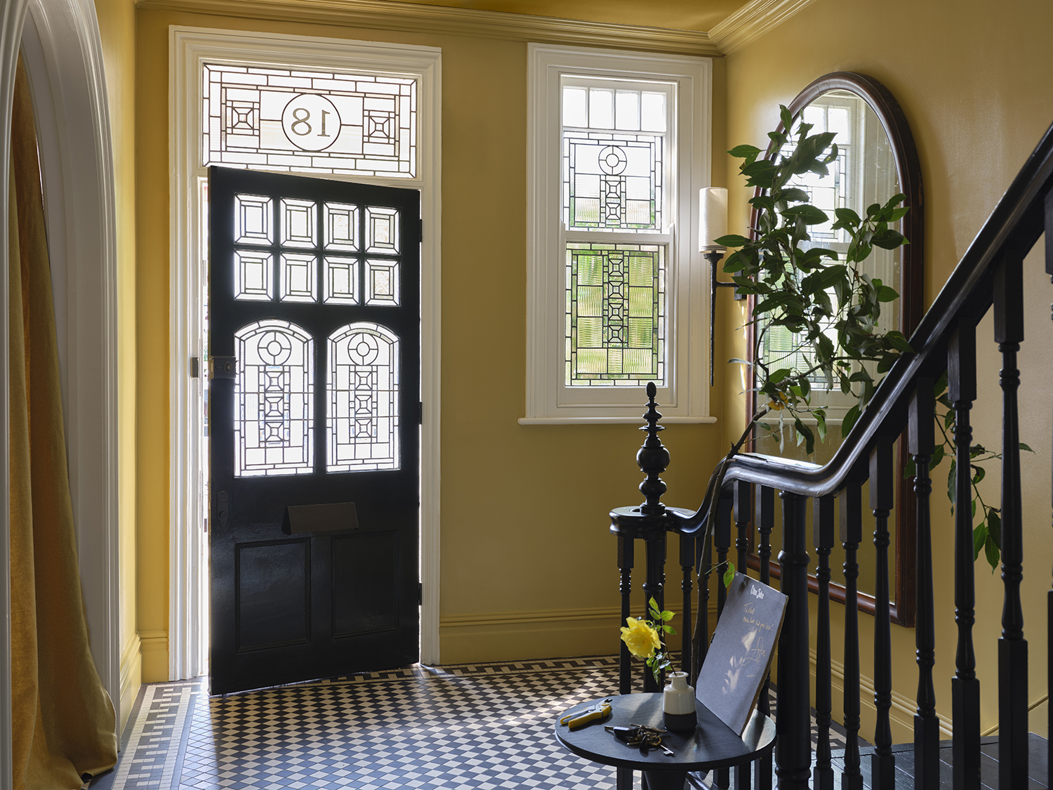 An entryway painted in Duster, an aged yellow, from Farrow & Ball's newest color introductions.