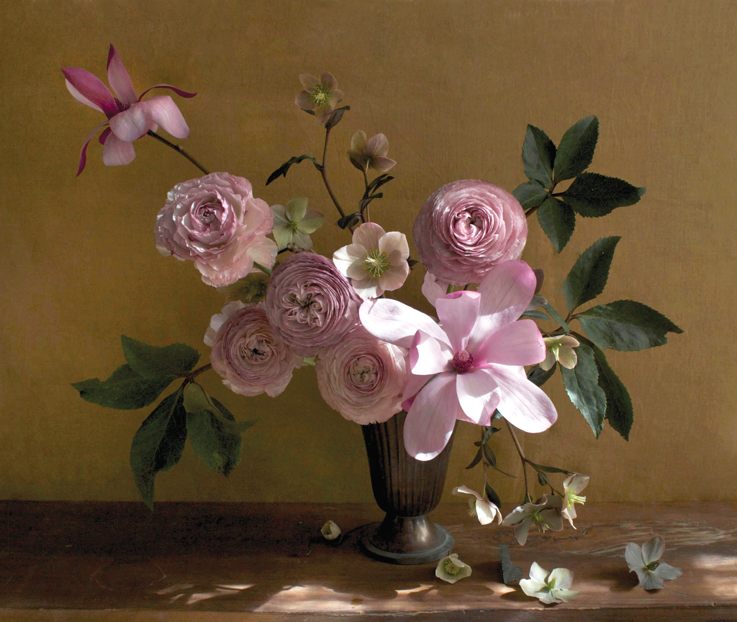 An arrangement of magnolias, ranunculus, and hellebores by floral designer Ariel Dearie.