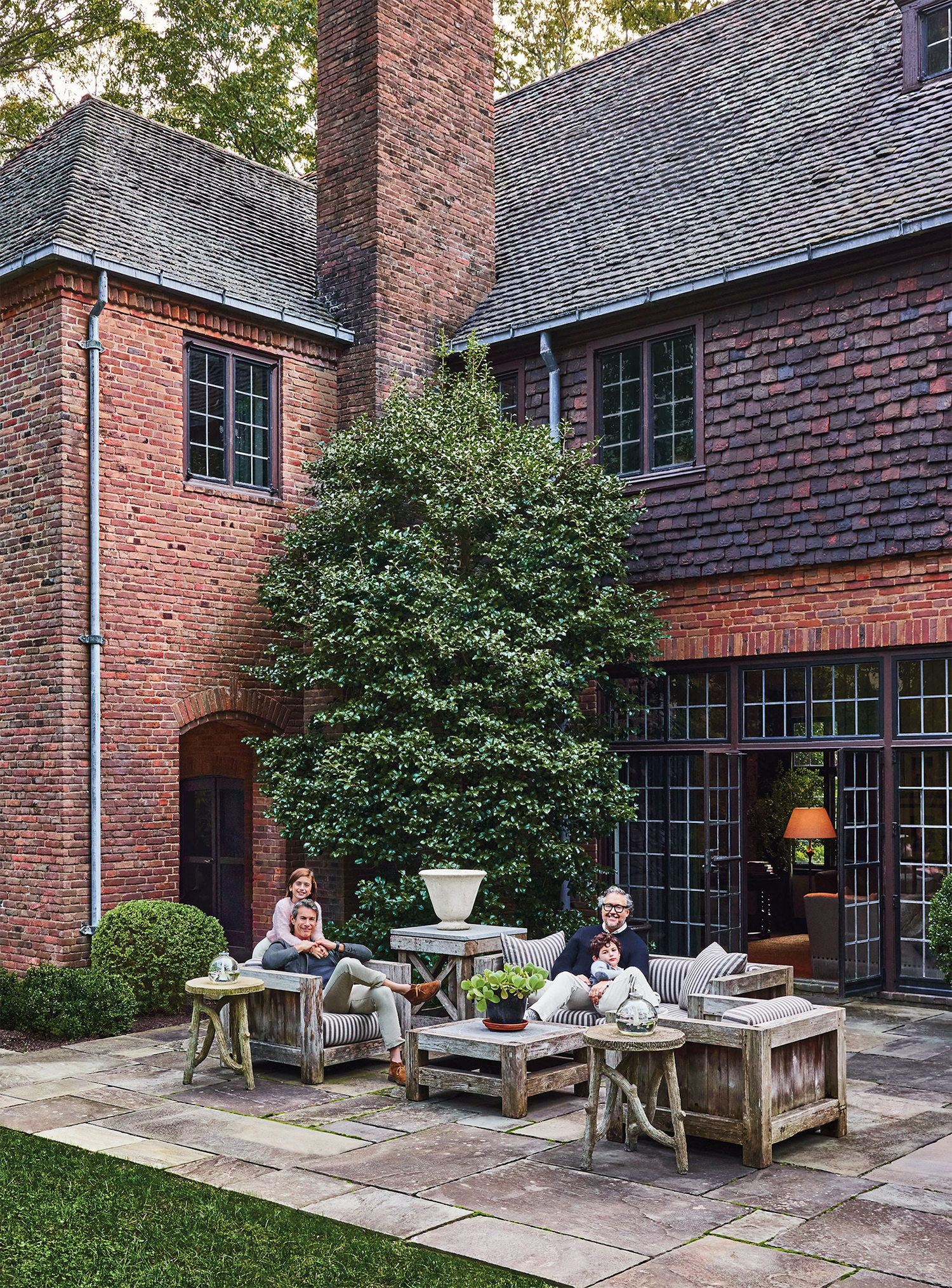 Paredes, his husband Brad Goldfarb, and their two children at their home in Locust Valley, New York.