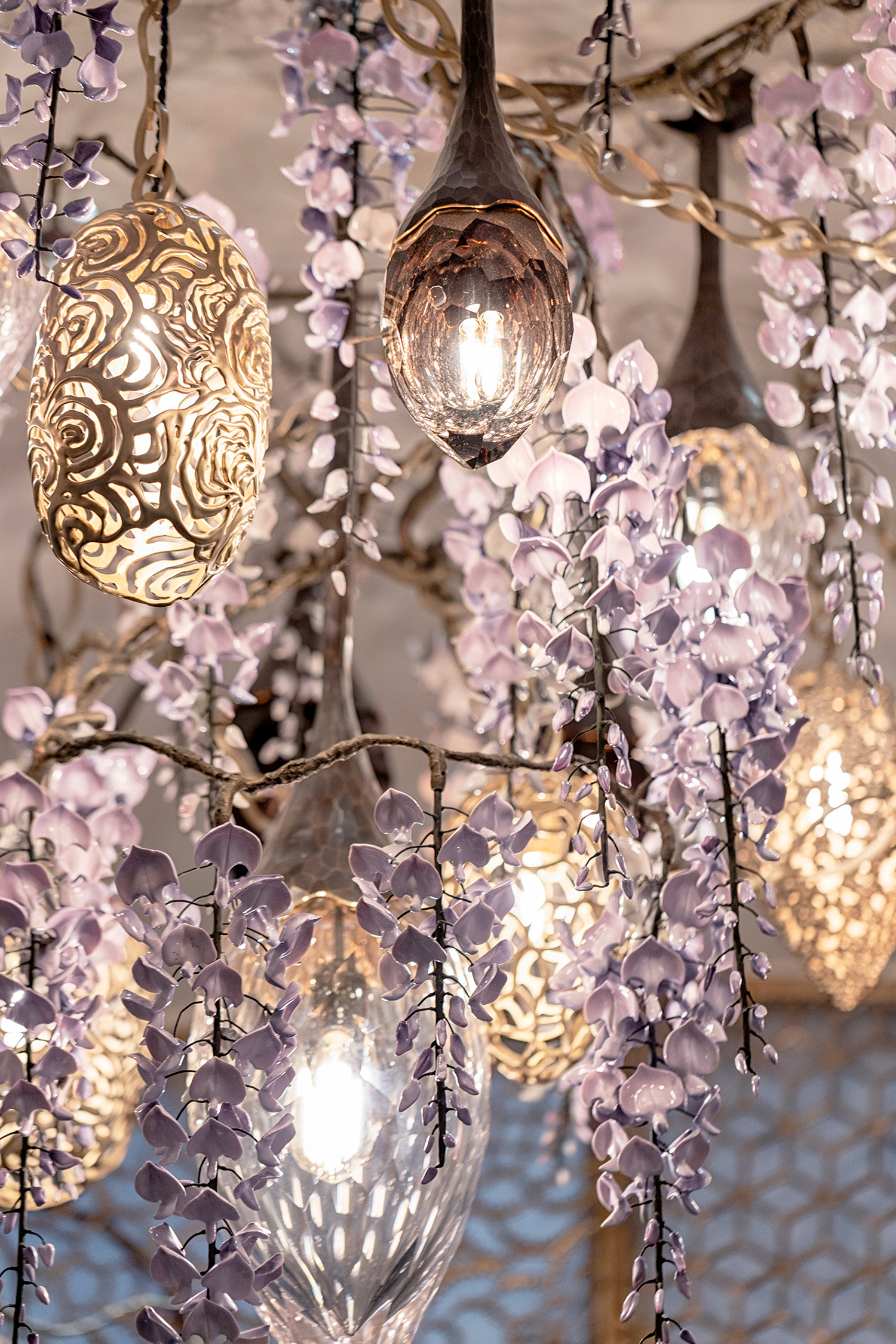 Hand-sculpted porcelain wisteria blooms illuminated with amethyst cut crystal pendants and bronze lanterns.