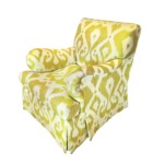 Green and white patterned armchair with a plush design on a white background.